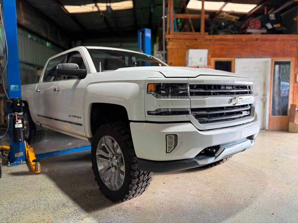 Lifted Chevy Silverado on the lift for ABS module replacement in North Little Rock, Arkansas