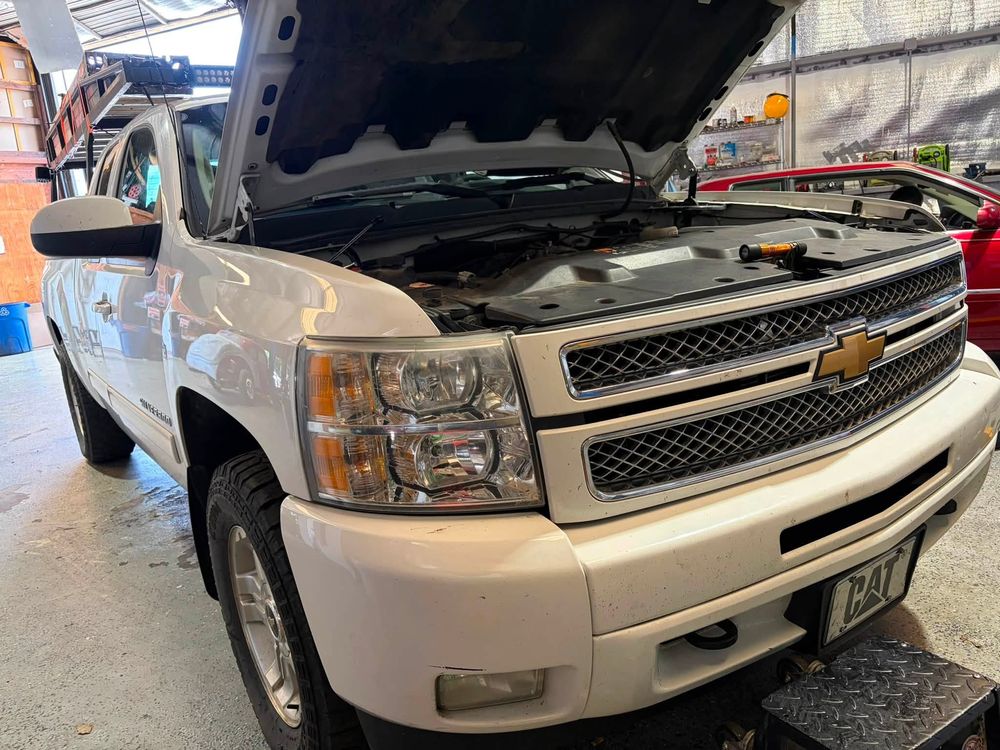 Chevy Silverado with the hood up for AC work after an engine rebuild in North Little Rock, Arkansas