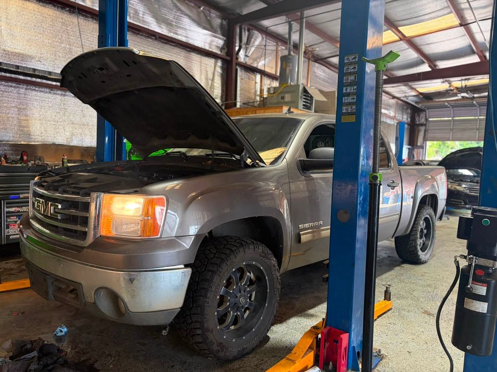 GMC Sierra on the lift for a remanufactured transmission replacement in North Little Rock, Arkansas
