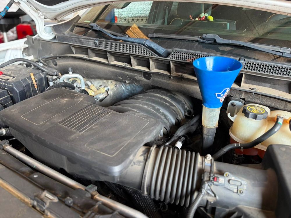 Oil being added to a GMC Yukon engine after an engine replacement in North Little Rock, Arkansas