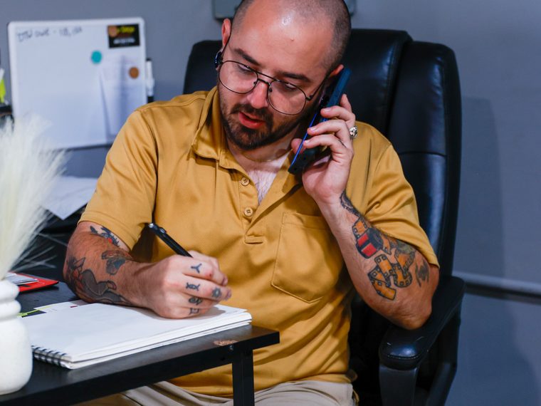 Ketcher, service advisor at The Shop, GM Repair, taking a customer call in North Little Rock, Arkansas