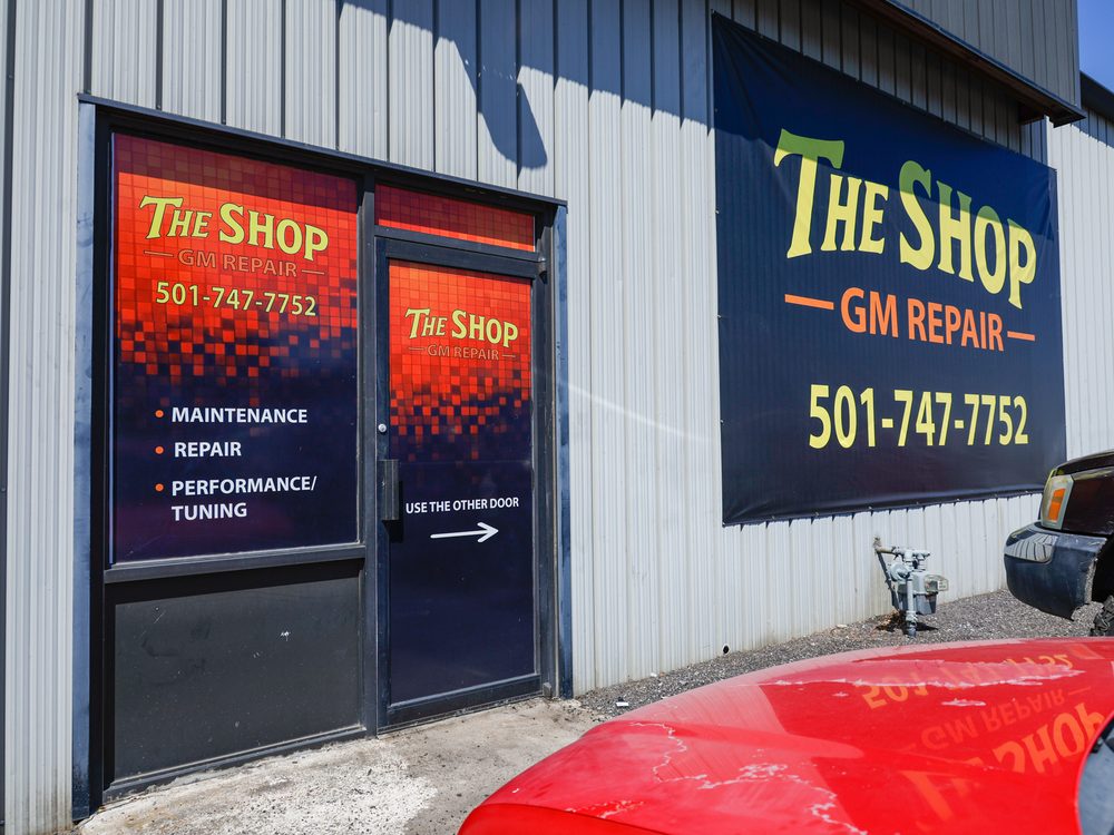 The front entrance and signage at The Shop, GM Repair on North Olive Street in North Little Rock, Arkansas