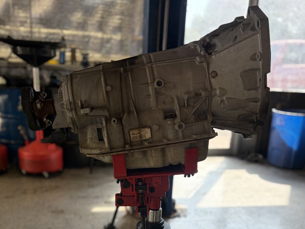 Automatic transmission out of the vehicle on a transmission jack during transmission service in North Little Rock, Arkansas
